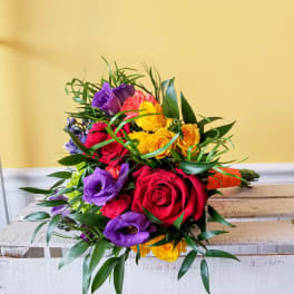 Bouquet of multicolored roses and purple lisianthus with greenery
