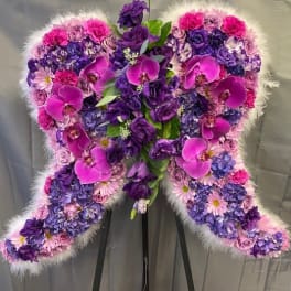 Heart-shaped floral standing spray in pink and purple tones