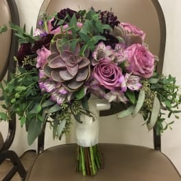 Bouquet of pink roses, succulents, and greenery