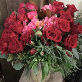 Bouquet of red and pink roses in a striped vase