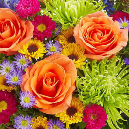 Bouquet of orange roses and colorful daisies
