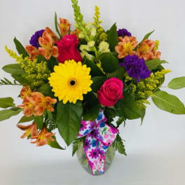 Mixed bouquet with roses, gerbera daisy, and alstroemeria in a glass vase