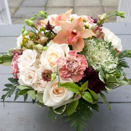 Peach and white floral bouquet with roses and orchids