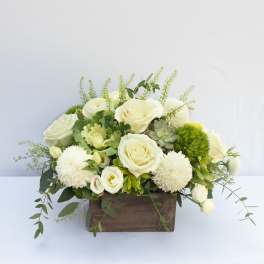 White roses and pompom blooms in a wooden box arrangement
