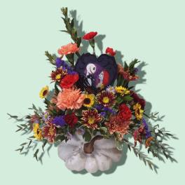 Colorful floral arrangement with a heart-shaped Halloween centerpiece