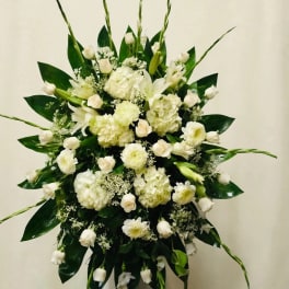 Large white floral spray with hydrangeas, roses, and lilies