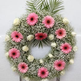Pink gerbera daisy wreath with white roses and baby's breath