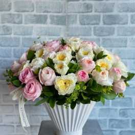 Pink and white rose bouquet in a white ribbed vase