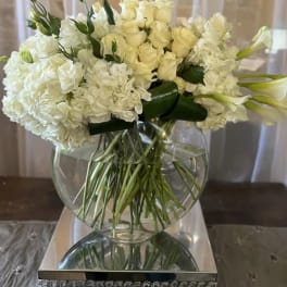 White floral arrangement in a clear glass vase