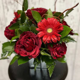 Red rose bouquet with a red gerbera daisy and green foliage
