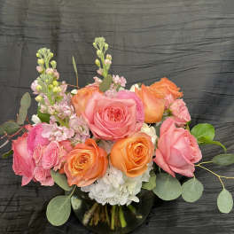Pink and orange rose bouquet in a glass vase
