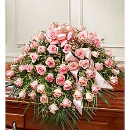 Large pink rose casket spray with white ribbons