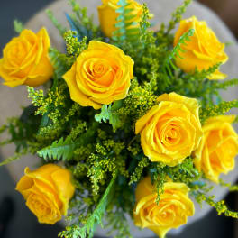 Bouquet of yellow roses with green filler flowers