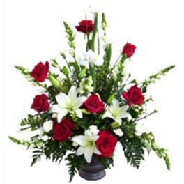 Red roses and white lilies in a dark vase