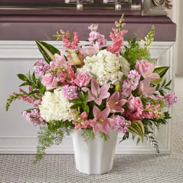 Pink and white floral arrangement in a white vase