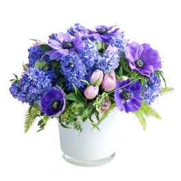 Purple and blue flowers arranged in a white vase