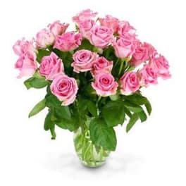 Bouquet of multiple pink roses arranged in a clear glass vase