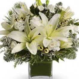 White lilies and white flowers in a square glass vase