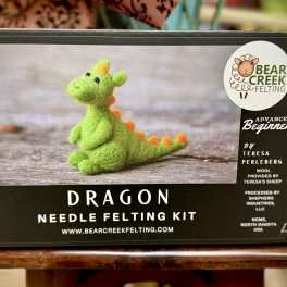 Boxed dragon needle felting kit with a green felt dragon on the front