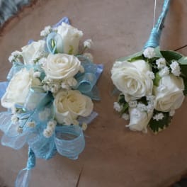 Two white rose wedding bouquets with blue ribbon accents