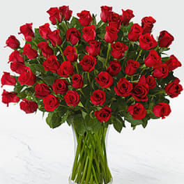 Large bouquet of red roses in a clear glass vase
