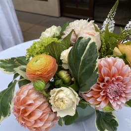 Pastel bouquet with pink dahlias, ranunculus, and white blooms in a vase