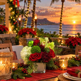 Red roses and white hydrangea in a glass vase with holiday decor