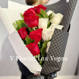 Bouquet of red and white roses wrapped in black and white paper