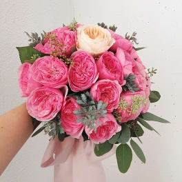 Pink and cream rose bouquet with a pale ribbon