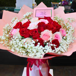 Bouquet of red and pink roses wrapped in pink paper