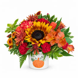 Fall bouquet in a white pumpkin vase with sunflowers and mixed blooms
