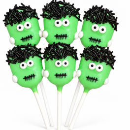 Six green Frankenstein face cake pops with white sticks on a white background.
