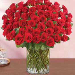 Large bouquet of red roses in a clear glass vase