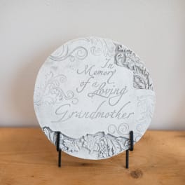 Round memorial plaque on a stand with engraved text for a grandmother