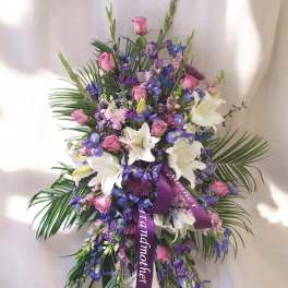 Purple and pink floral spray with white lilies and roses
