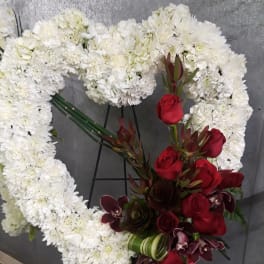 White floral heart wreath with red roses and dark orchids