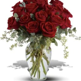 Red roses arranged in a clear glass vase