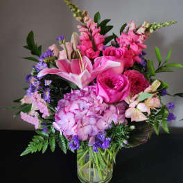 Pink and purple mixed bouquet in a clear glass vase