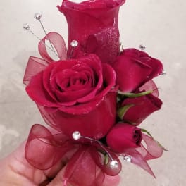 Handheld bouquet of deep pink roses with ribbon and crystal picks