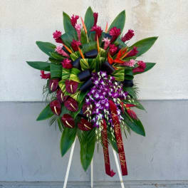 Large tropical floral standing spray with purple orchids and red blooms
