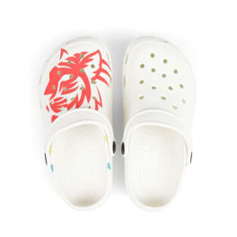 Pair of white clogs with red animal graphics and perforations