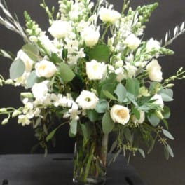 White floral arrangement in a clear glass vase