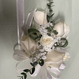 White rose bouquet with ribbon and greenery accents