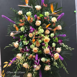 Large tropical floral spray with roses, orchids, and purple spikes