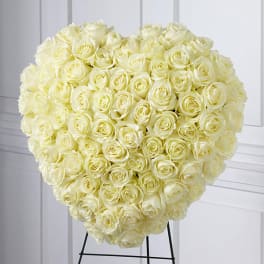 Heart-shaped bouquet of cream roses on a stand