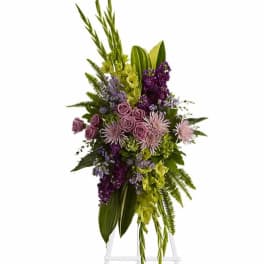 Tall floral spray with purple and green flowers on a stand