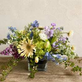 Mixed pastel bouquet in a square glass vase