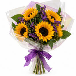 Bouquet of sunflowers with purple filler flowers wrapped in clear plastic and tied with a purple ribbon