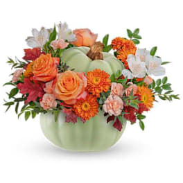 Autumn floral arrangement in a pale green pumpkin vase