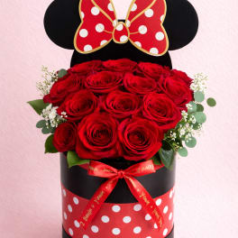 Red roses in a black round box with a Minnie Mouse bow topper